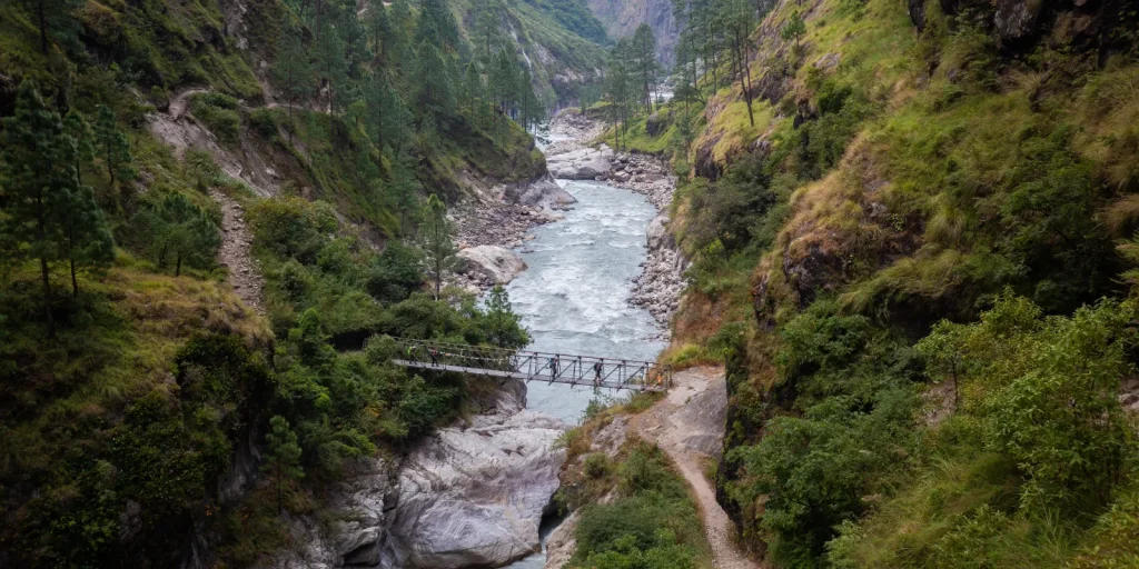 Snow View Trek View over a valley with a bridge during Manaslu Ci